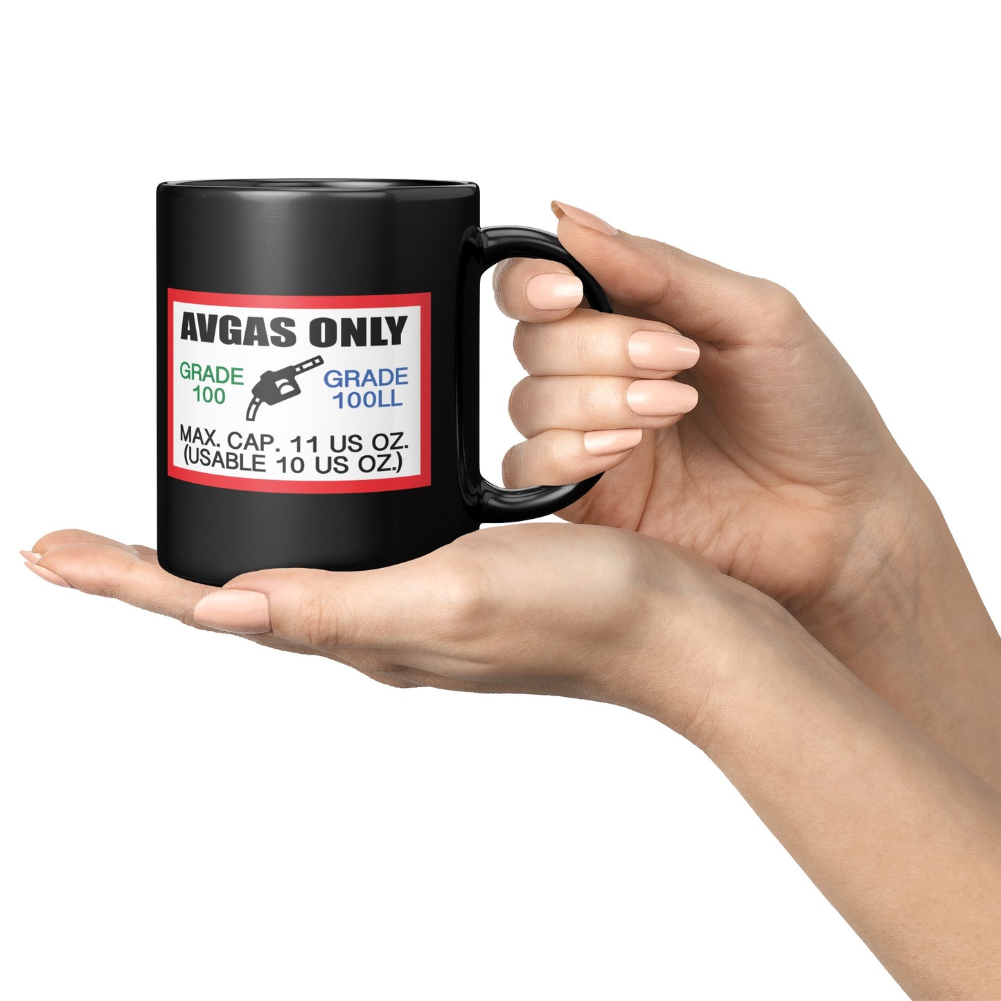 Black mug with aviation fuel label design held by a hand on a white background