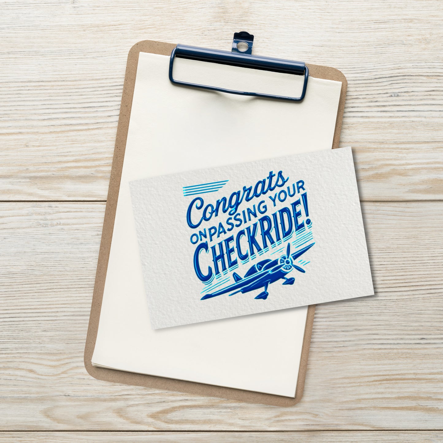 Note with 'Congrats on passing your checkride!' text and airplane graphic on a clipboard.